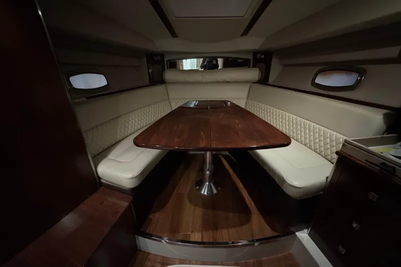 Slide: The Image of Cozy cabin interior of 2015 Chaparral 330 Signature with decorative pillows and ambient lighting. - 40