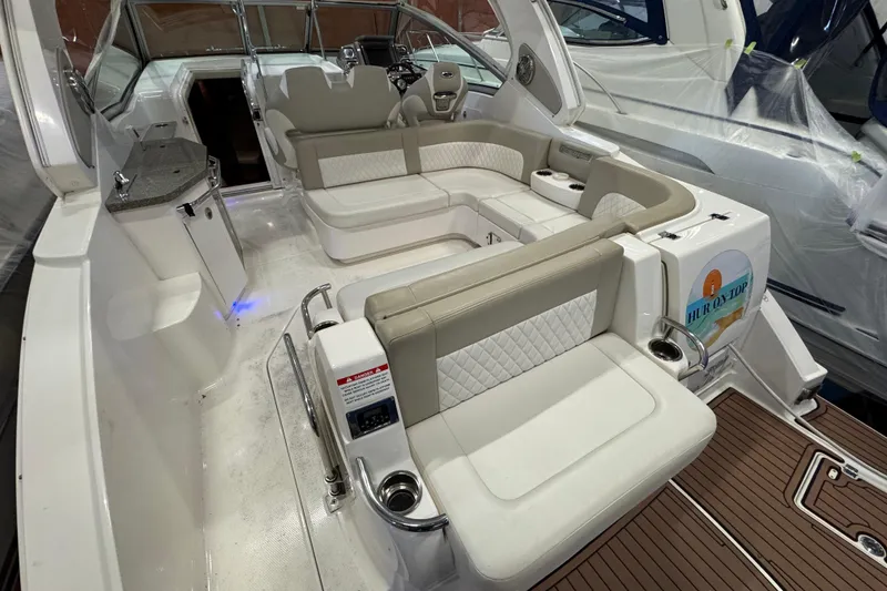 Slide: The Image of 2015 Chaparral 330 Signature boat interior with luxurious seating and modern amenities. - 5
