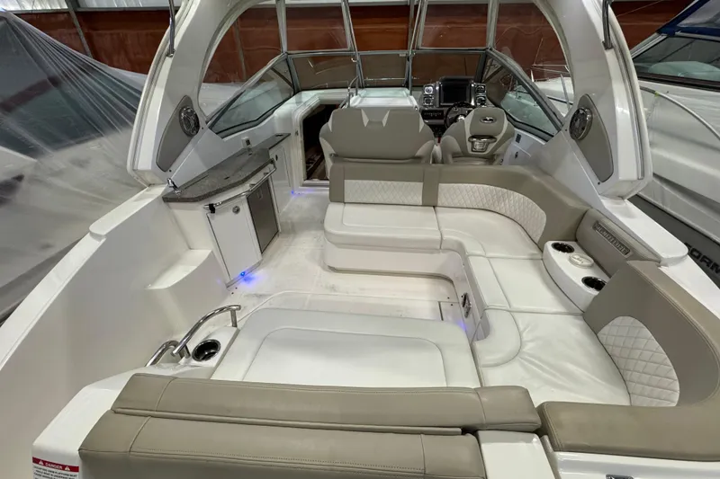 Slide: The Image of 2015 Chaparral 330 Signature boat interior with luxurious seating and modern amenities. - 7
