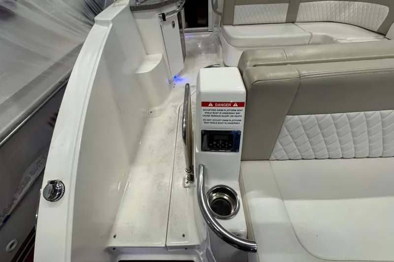 Slide: The Image of 2015 Chaparral 330 Signature boat interior with seating and safety warning label. - 8