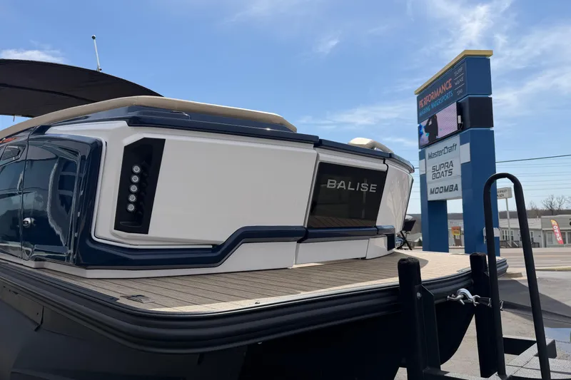 Slide: The Image of 2025 Balise HORIZON26C boat displayed outdoors with dealership signage in background. - 11
