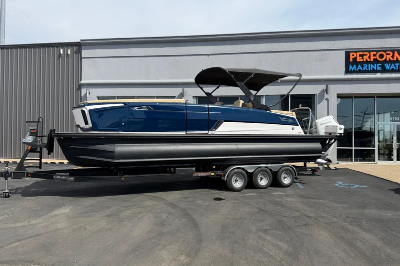 Slide: The Image of 2025 Balise HORIZON26C boat on trailer outside marine dealership. - 2