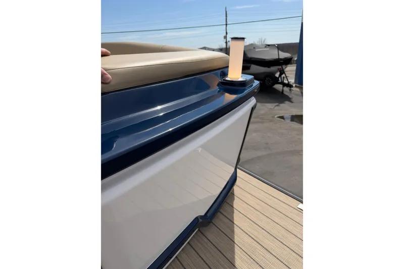 Slide: The Image of Balise HORIZON26C 2025 boat detail with blue and beige seating, docked outdoors. - 28