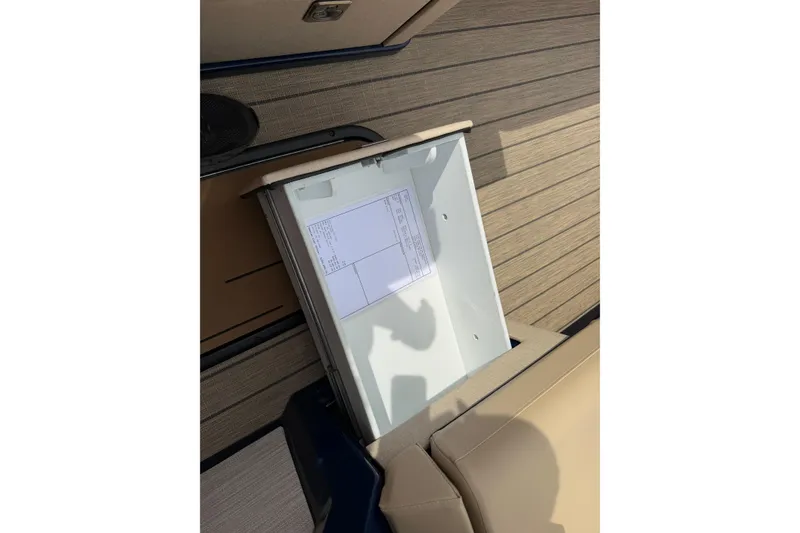 Slide: The Image of Open storage compartment on Balise HORIZON26C boat, 2025 model, with document inside. - 30