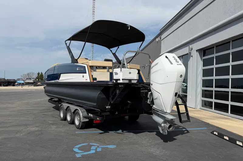 Slide: The Image of Balise HORIZON26C 2025 boat with Mercury engine on trailer, parked outside a building. - 4