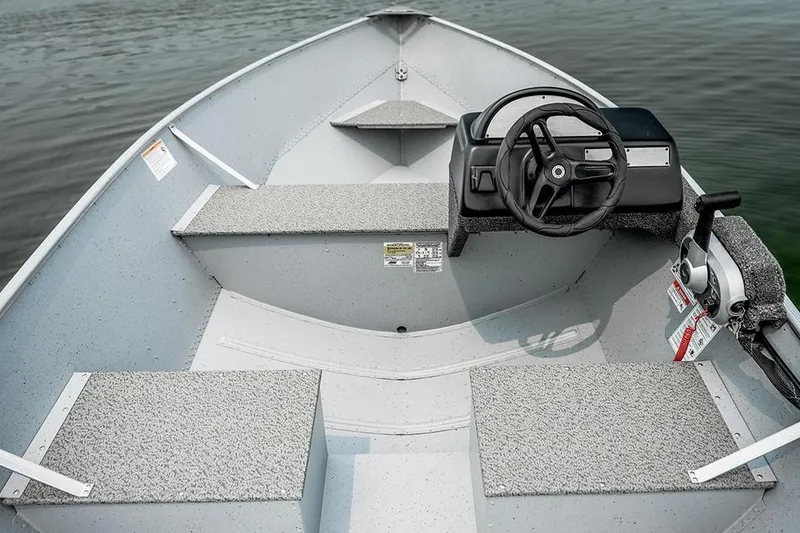 Slide: The Image of Manufacturer Provided Image: 2026 Lund SSV-16 boat interior with steering wheel and seating, on calm water. - 3