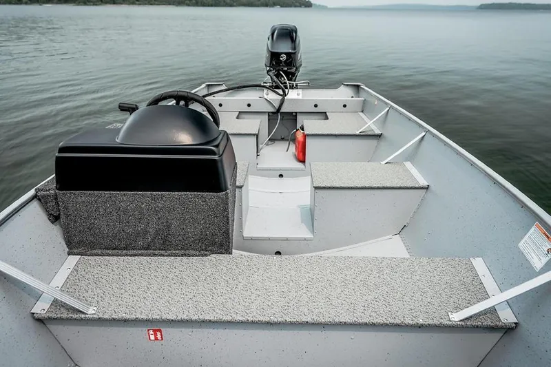 Slide: The Image of Manufacturer Provided Image: 2026 Lund SSV-16 boat interior with steering console on calm lake. - 5