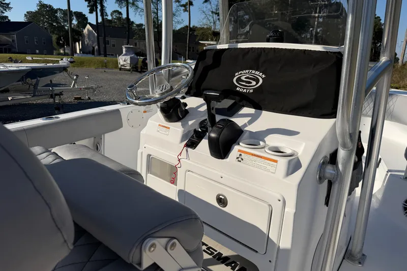 Slide: The Image of 2019 Sportsman Heritage 231 Center Console boat interior with steering wheel and controls. - 10
