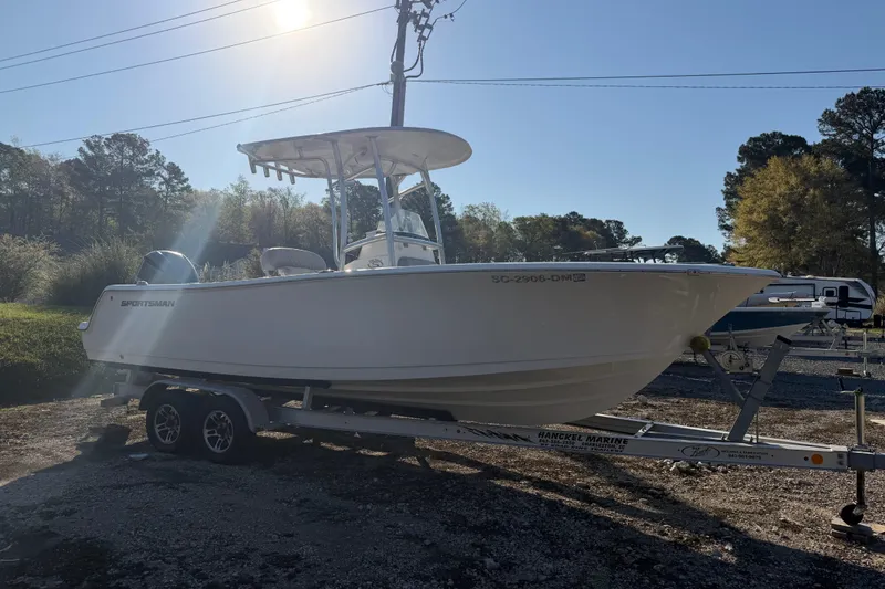 Slide: The Image of 2019 Sportsman Heritage 231 Center Console boat on trailer in sunny outdoor setting. - 3