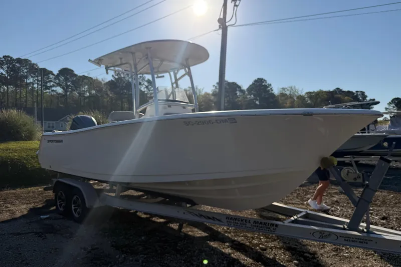 Slide: The Image of 2019 Sportsman Heritage 231 Center Console boat on trailer in outdoor setting. - 4