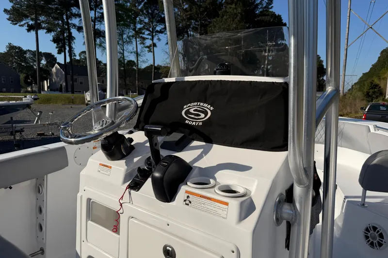 Slide: The Image of 2019 Sportsman Heritage 231 Center Console boat dashboard with steering wheel and controls. - 7