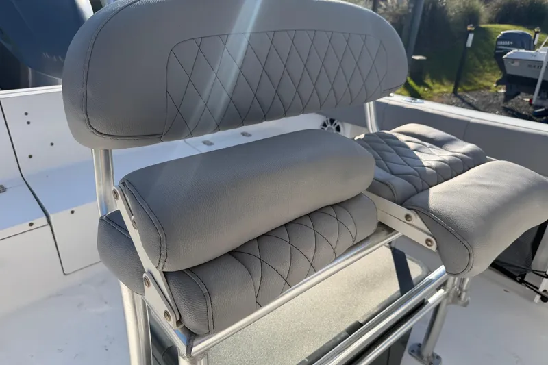 Slide: The Image of 2019 Sportsman Heritage 231 Center Console boat seat with gray cushioned upholstery. - 9