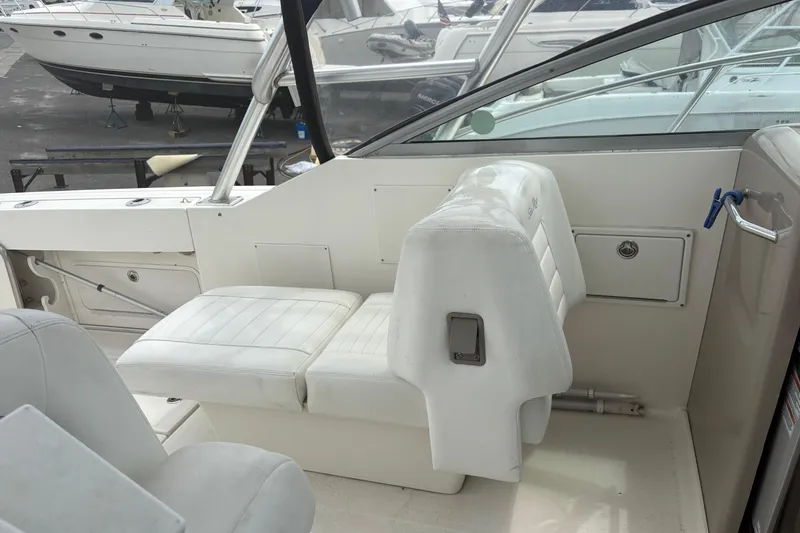 Slide: The Image of 2008 Searay 290 AMBERJACK boat interior with white seating and control panel. - 12