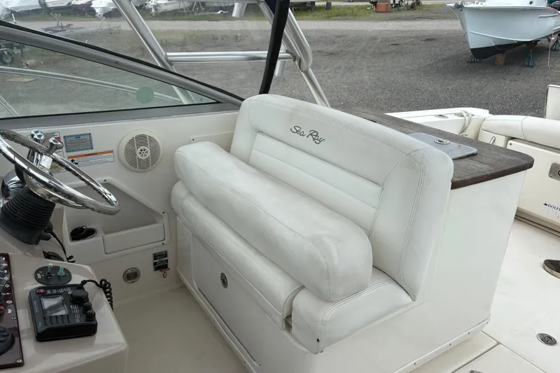 Slide: The Image of 2008 Searay 290 Amberjack boat interior with steering wheel and white seating. - 13