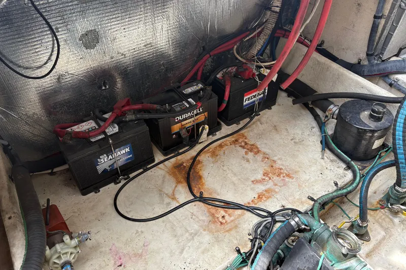 Slide: The Image of Battery compartment of a 2008 Searay 290 AMBERJACK with marine batteries and wiring. - 7