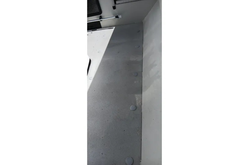 Slide: The Image of 2024 Ranger RB200 boat interior with gray flooring and circular fixtures. - 19