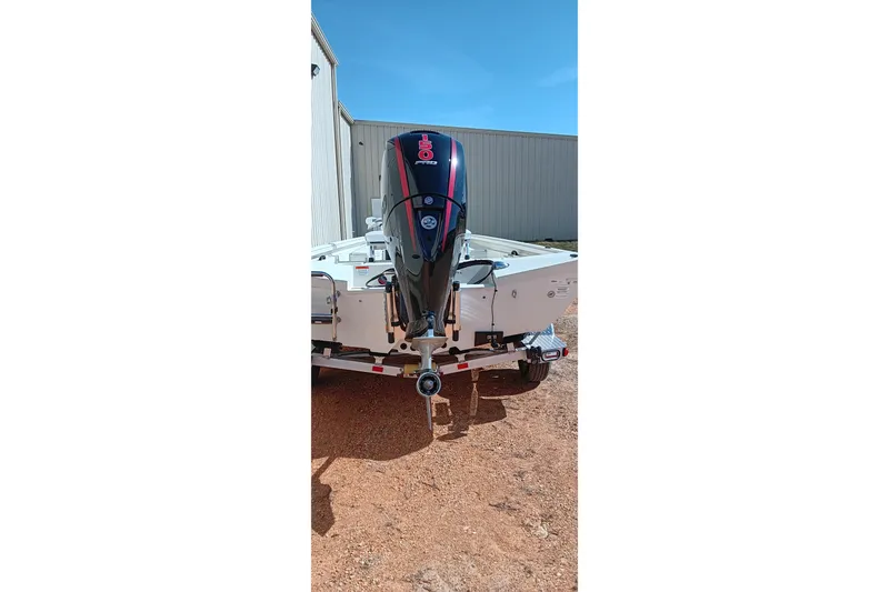 Slide: The Image of 2024 Ranger RB200 boat with powerful outboard motor, parked outdoors. - 2