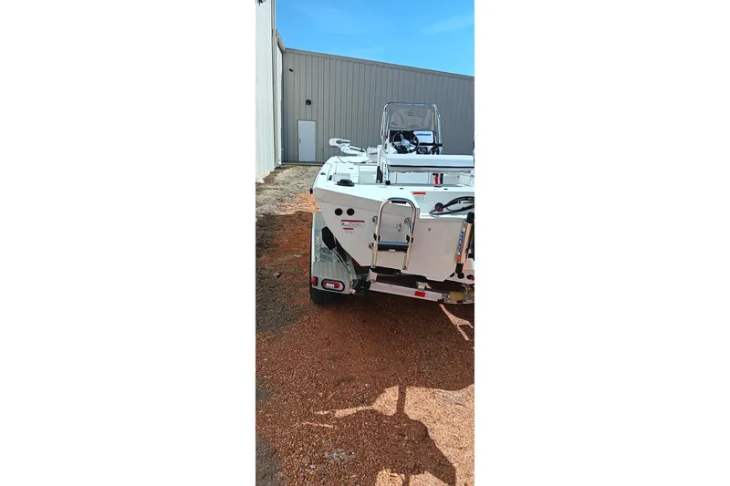 Slide: The Image of 2024 Ranger RB200 boat on trailer, parked outside a building. - 3