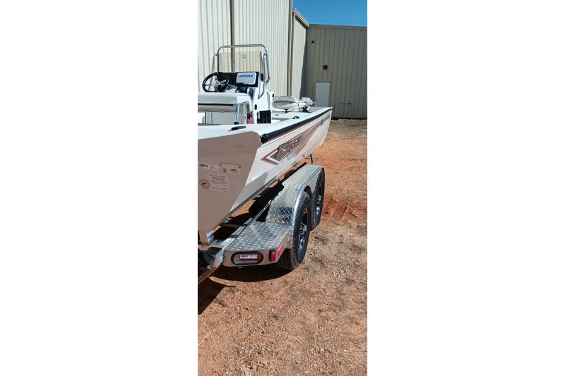 Slide: The Image of 2024 Ranger RB200 boat on trailer, parked outdoors near a building. - 5