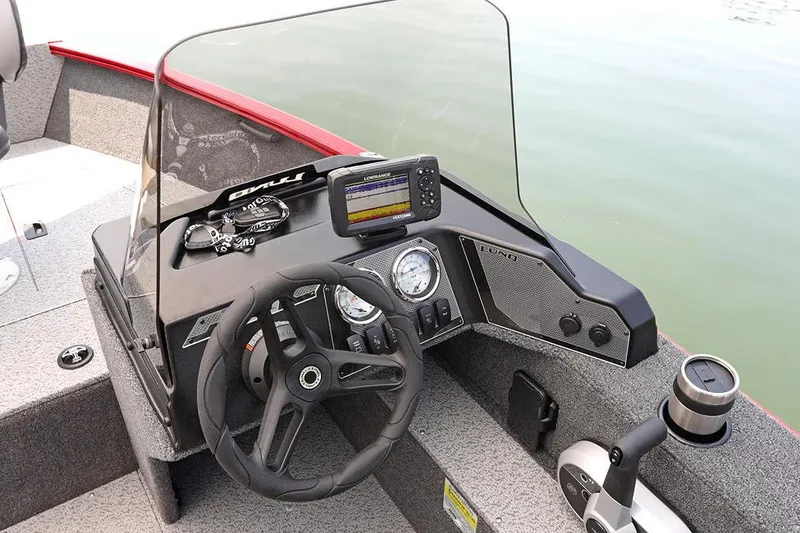 Slide: The Image of Manufacturer Provided Image: 2025 Lund 1650 Rebel XL SS boat dashboard with steering wheel and navigation system. - 7