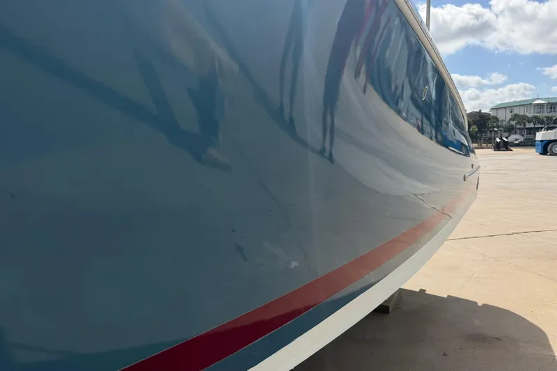 Slide: The Image of Side view of a 2001 Chris-Craft Launch 28 boat on a sunny day. - 12