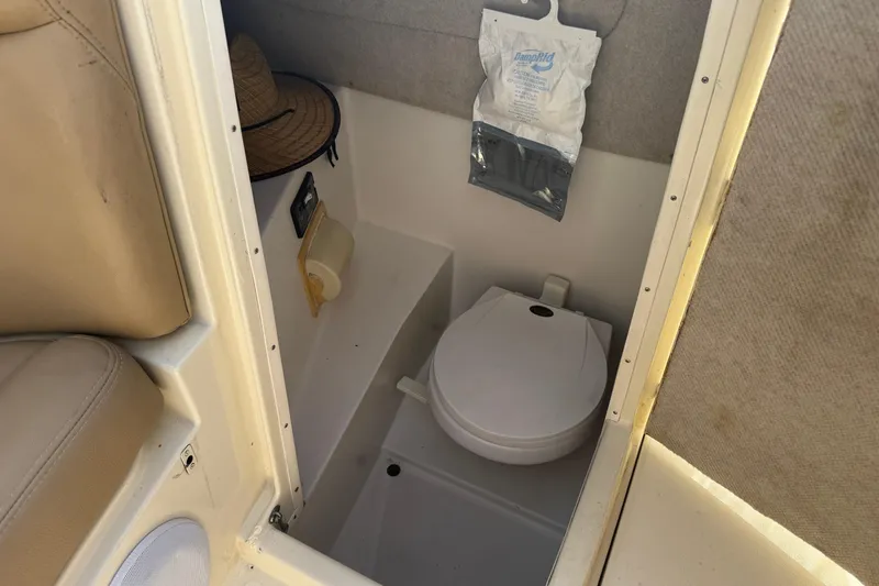 Slide: The Image of Interior of 2001 Chris-Craft Launch 28 boat with compact toilet and storage. - 16