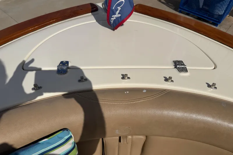 Slide: The Image of 2001 Chris-Craft Launch 28 boat interior with beige seating and storage compartment. - 18