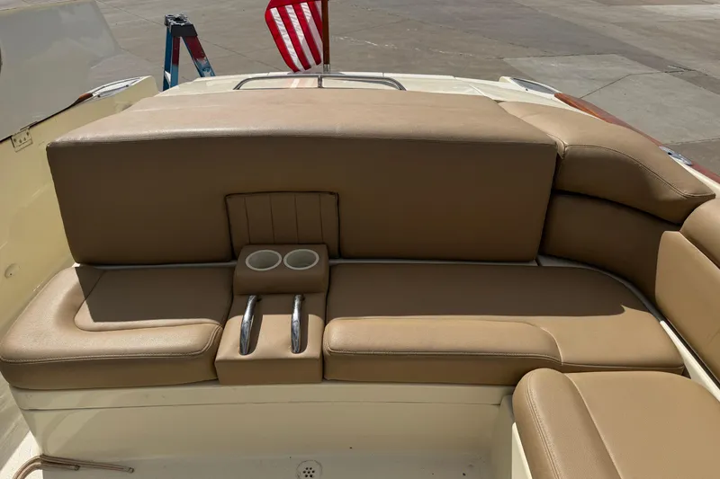 Slide: The Image of 2001 Chris-Craft Launch 28 boat interior with tan leather seating and cup holders. - 23