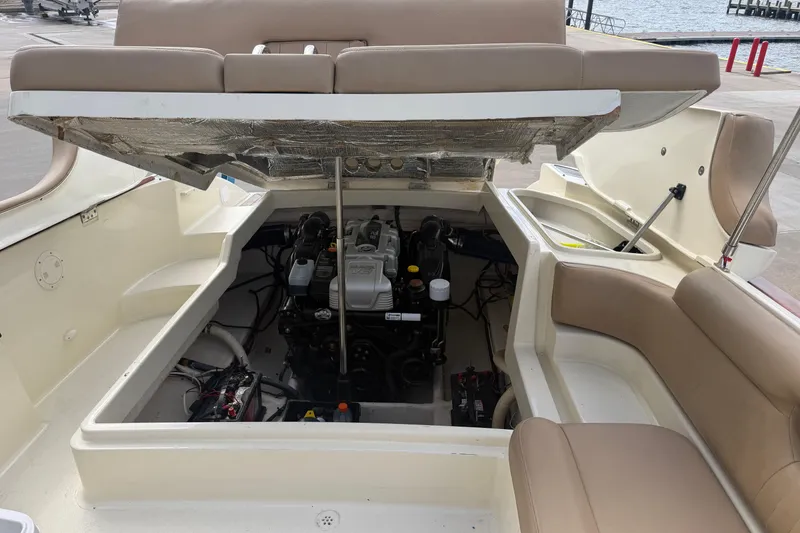 Slide: The Image of 2001 Chris-Craft Launch 28 boat engine compartment with open hatch, dockside view. - 28