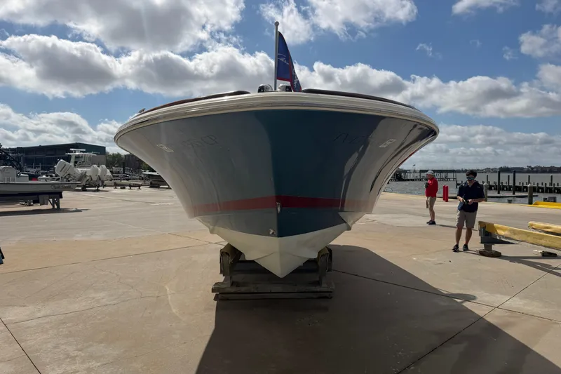 Slide: The Image of 2001 Chris-Craft Launch 28 boat on a dock under a partly cloudy sky. - 5