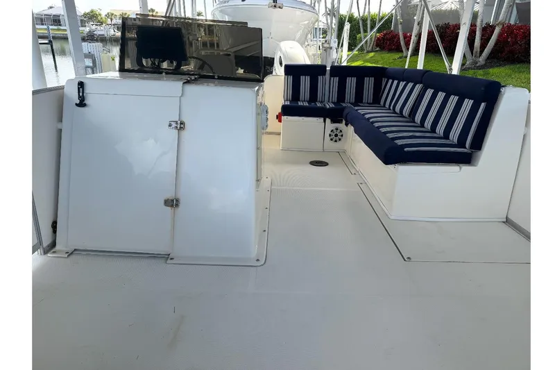 Slide: The Image of 2017 Beachcat 230 boat interior with striped seating and storage compartments. - 11