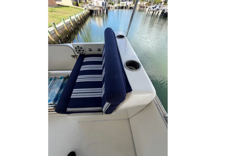 Slide: The Image of Blue-striped seating on a 2017 Beachcat 230 boat by a canal. - 14