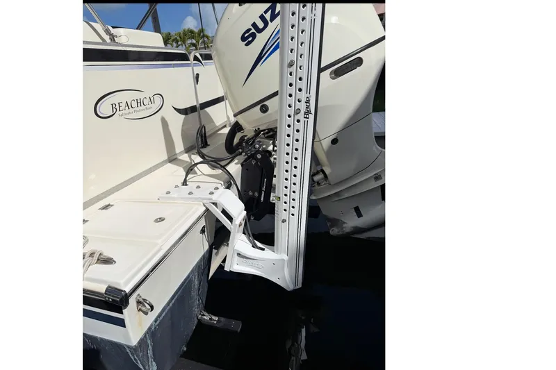 Slide: The Image of 2017 Beachcat 230 boat with Suzuki outboard motor and power pole. - 17