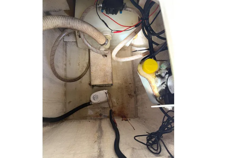 Slide: The Image of Interior view of a 2017 Beachcat 230 boat showing wiring and hoses. - 20