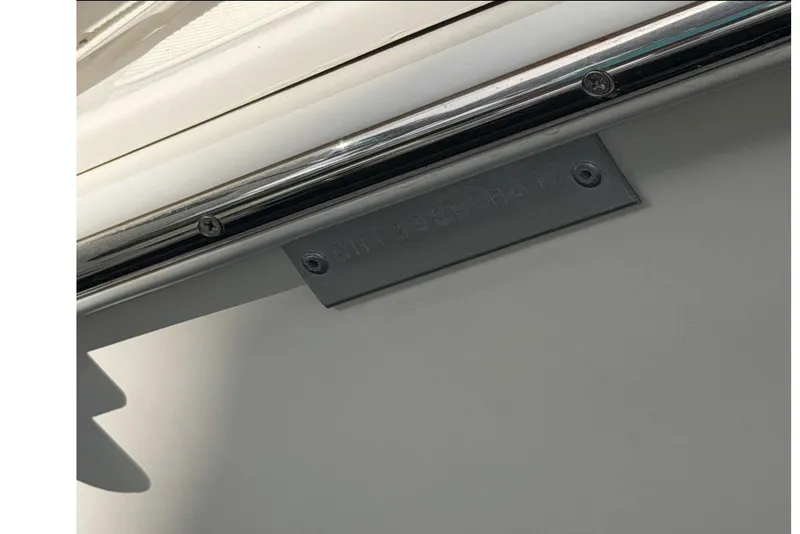 Slide: The Image of Close-up of a 2017 Beachcat 230 boat's identification plate and railing. - 21