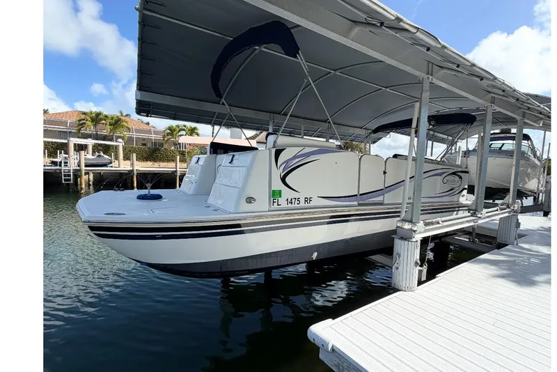 Slide: The Image of 2017 Beachcat 230 boat docked under canopy on a sunny day. - 23