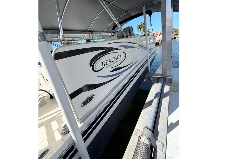 Slide: The Image of 2017 Beachcat 230 boat docked under a canopy on a sunny day. - 3