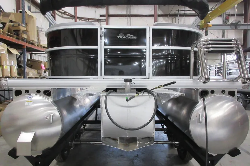 Slide: The Image of 2026 Sun Tracker Party Barge 22 DLX pontoon boat in warehouse setting. - 2