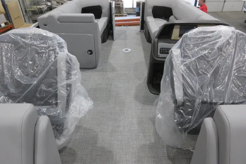 Slide: The Image of 2026 Sun Tracker Party Barge 22 DLX interior with plastic-covered seats and modern design. - 4