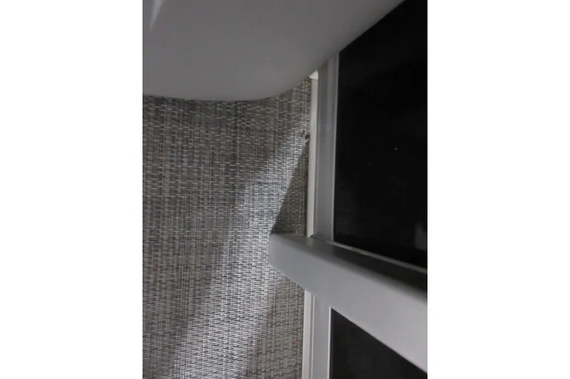 Slide: The Image of Interior detail of 2026 Sun Tracker Party Barge 22 DLX, featuring woven upholstery and sleek design. - 7