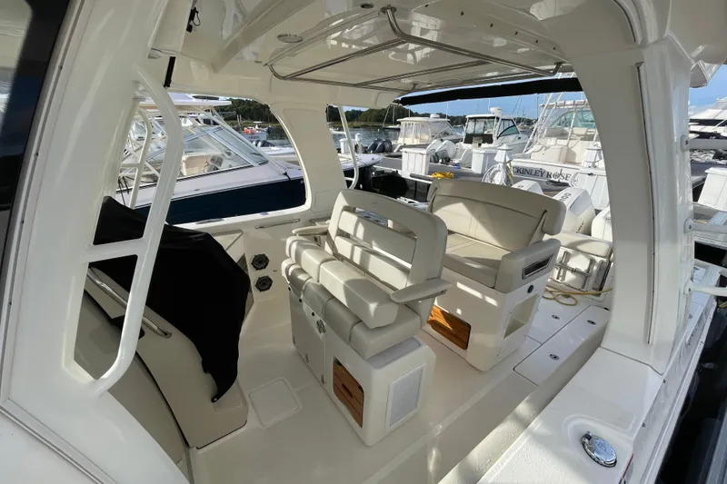 Slide: The Image of Interior view of a 2022 Boston Whaler 350 Realm boat, featuring luxurious seating and sleek design. - 11