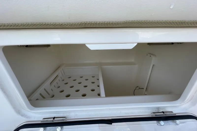 Slide: The Image of Storage compartment of a 2022 Boston Whaler 350 Realm boat, featuring organized shelving. - 15