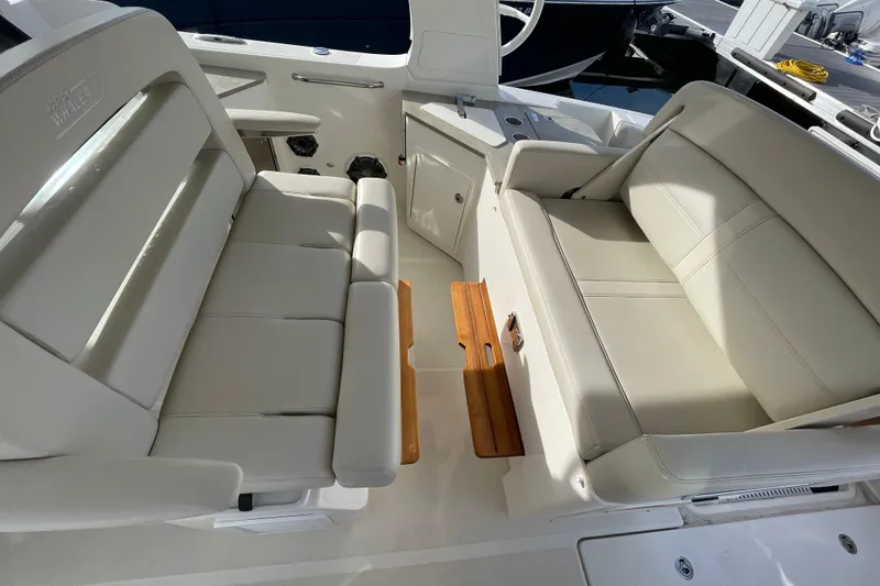 Slide: The Image of Interior seating of 2022 Boston Whaler 350 Realm boat, featuring luxurious white upholstery. - 17