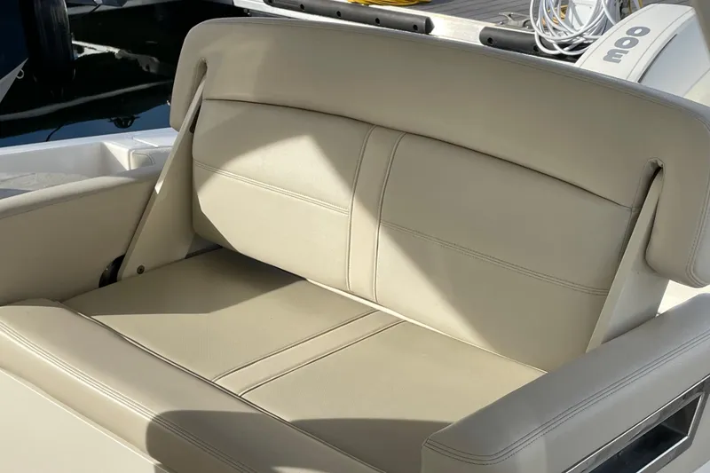 Slide: The Image of 2022 Boston Whaler 350 Realm boat seat with beige upholstery in sunlight. - 18
