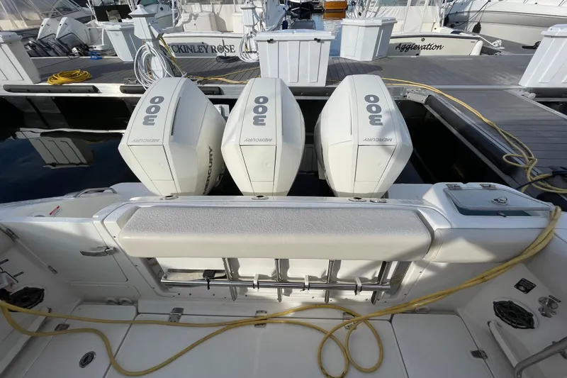 Slide: The Image of Boston Whaler 350 Realm 2022 with triple Mercury 300 engines at dock. - 21