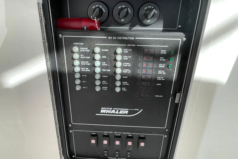 Slide: The Image of Control panel of a 2022 Boston Whaler 350 Realm boat, featuring various switches and indicators. - 23