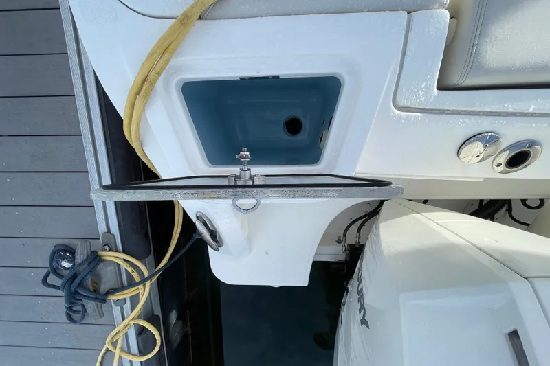 Slide: The Image of Boston Whaler 350 Realm 2022 boat stern with engine and dock ropes. - 24