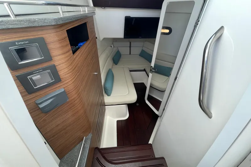 Slide: The Image of Interior of 2022 Boston Whaler 350 Realm, featuring modern seating and control panels. - 25