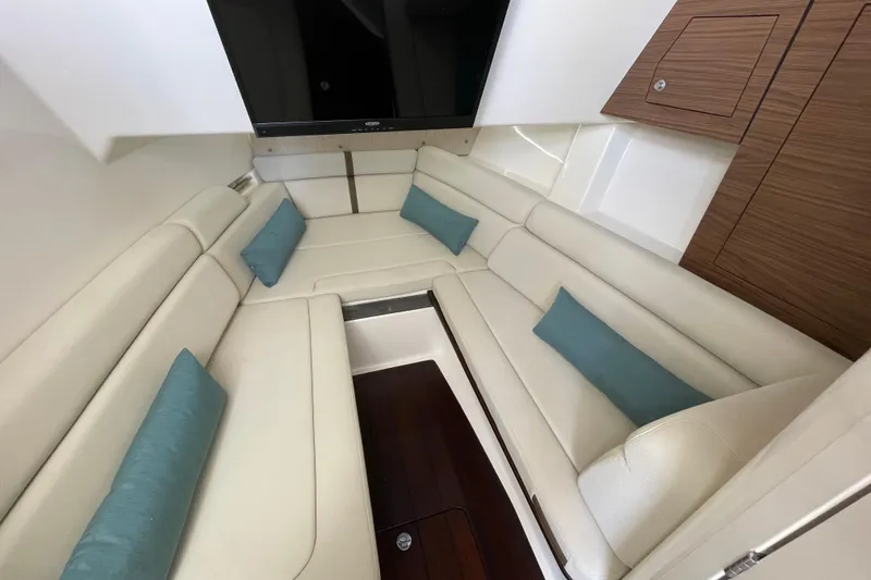 Slide: The Image of Luxurious interior of 2022 Boston Whaler 350 Realm with cream seating and teal cushions. - 26