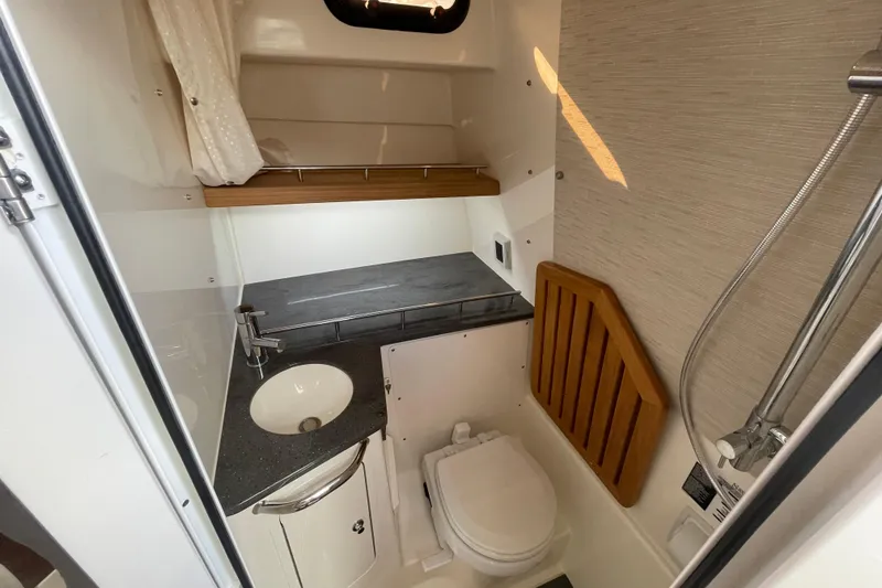 Slide: The Image of 2022 Boston Whaler 350 Realm bathroom with sink, toilet, and shower. - 27